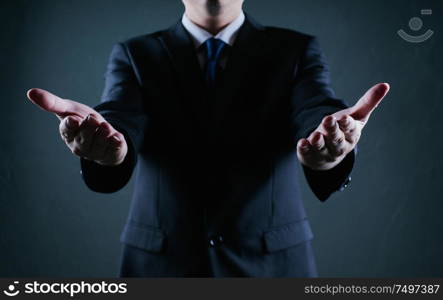 Businessman hold gesture pose . Low key lighting .