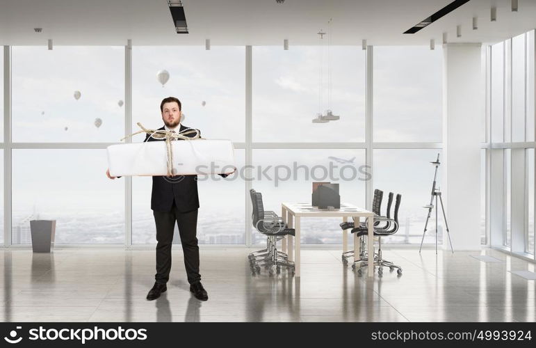 Businessman hold gift box. Young businessman in office with boxes of gifts in hands