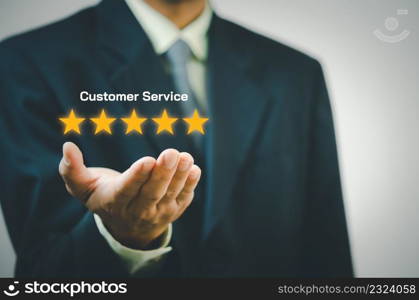 Businessman holding 5 stars on hands.Customer satisfaction and marketing survey rating concept