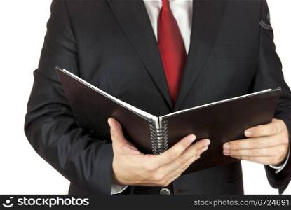 Businessman holding a black notebook in his hands