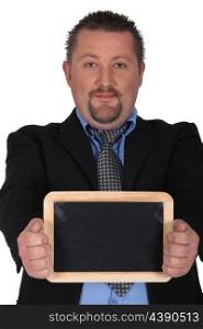 Businessman holding a blackboard left blank for your message
