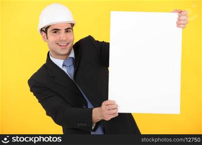 Businessman holding a blank poster