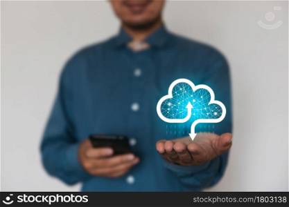 Businessman holding a cloud data icon with light and multimedia icon Application icon. Computing data on network. Insurance Business computer security concept.