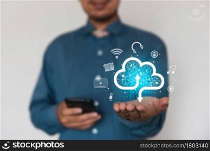 Businessman holding a cloud data icon with light. Computing data on network. Insurance Business computer security concept.