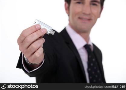 businessman holding a flash drive