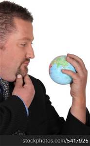 businessman holding a globe