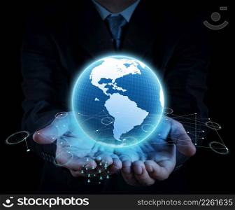 businessman holding a glowing earth globe in his hands