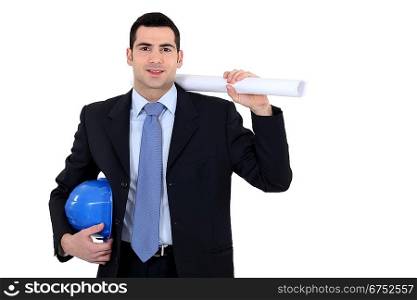 businessman holding a helmet and a blueprint
