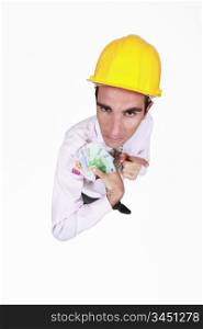 businessman holding a lot of money and pointing