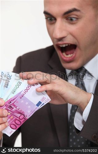 businessman holding a lot of money in cash