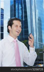 Businessman holding a mobile phone and smiling