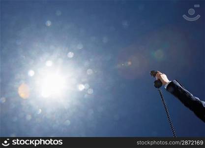 Businessman Holding a Phone in the Air