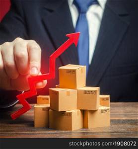 Businessman holding a red arrow up over boxes. Strategy marketing. Supply Demand. Increase sales rate, industrial goods production volumes growth , expanding export opportunities, finding new markets.