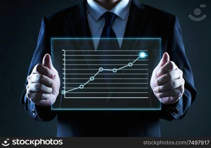 Businessman holding a screen glass with grow up financial state chart, business growth ideal concept .