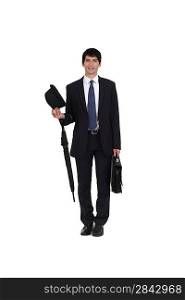 businessman holding an umbrella, a briefcase and a hat