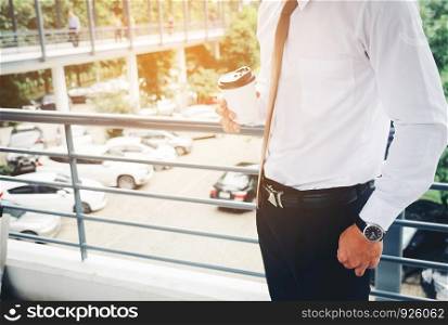 Businessman Holding and drinking a coffee after work