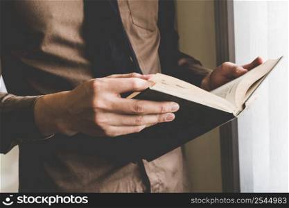 Businessman holding book at window. Creative Business Startup Idea.