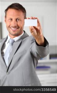 Businessman holding business card