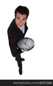 Businessman holding clock