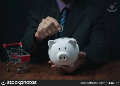 businessman holding coins putting in piggy bank. concept saving money for finance accounting and shopping.