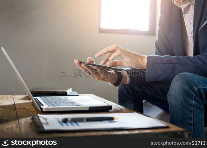 Businessman holding digital tablet or new technologies for success workflow at coffee shop or cafe desk