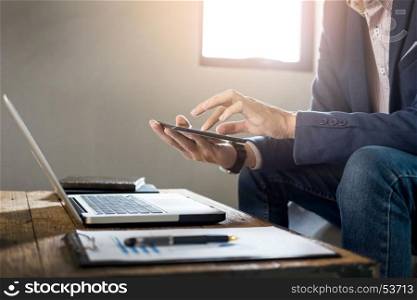 Businessman holding digital tablet or new technologies for success workflow at coffee shop or cafe desk