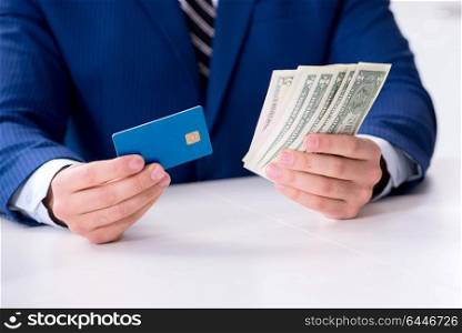 Businessman holding dollar money and credit card