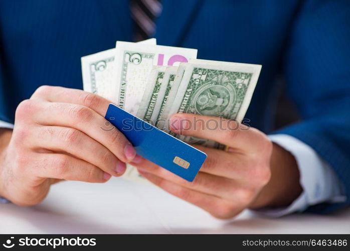 Businessman holding dollar money and credit card