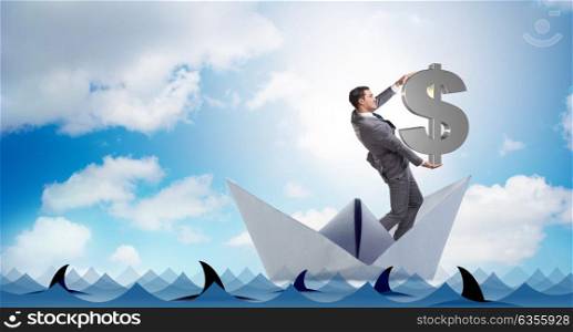 Businessman holding dollar riding paper ship boat