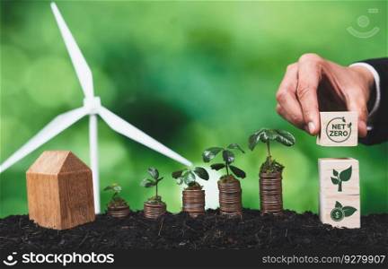 Businessman holding ESG symbol with seedling on coin stack and wind turbine. Environment social governance and corporate responsibility for sustainable energy to reduce CO2 pollution emission. Alter. Businessman holding ESG symbol with seedling on coin stack. Alter