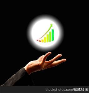 Businessman holding growing graph in abstract light