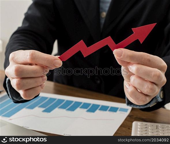 businessman holding growth arrow