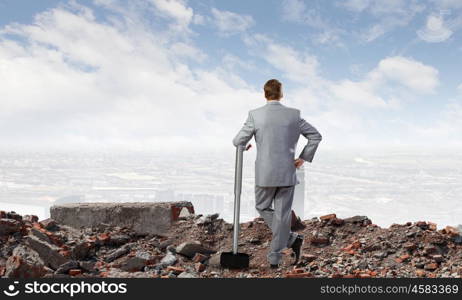 Businessman holding hammer. Rear view of determined businessman with big hammer in hands