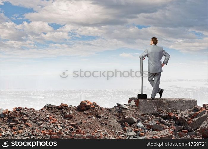 Businessman holding hammer. Rear view of determined businessman with big hammer in hands