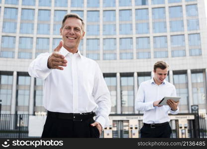 businessman holding hand out
