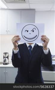 Businessman Holding Happy Face on Paper Over Face