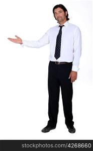 Businessman holding his hand out into open space