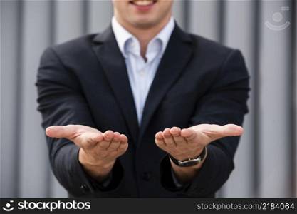businessman holding his hands out