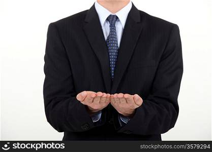 Businessman holding his hands straight palm-side up