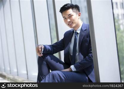 Businessman holding his mobile phone