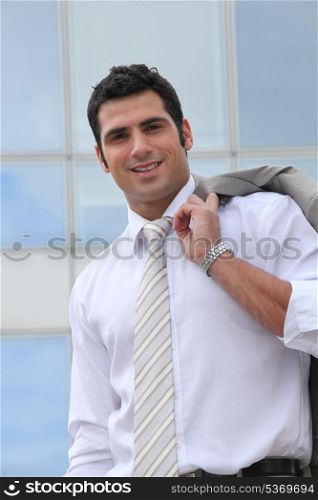 Businessman holding his suit jacket over his shoulder