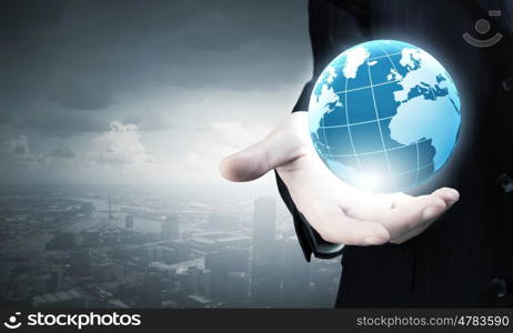 Businessman holding in palm digital Earth planet. Future world