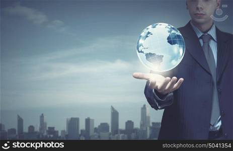 Businessman holding in palm digital Earth planet. Future world