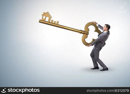 Businessman holding key in real estate concept. The businessman holding key in real estate concept