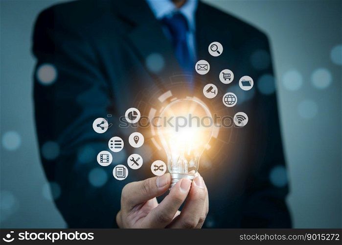 Businessman holding light bulb and new ideas. Creative and inspiration.business with innovative technology network connection. Innovation finance and economic growth concept.