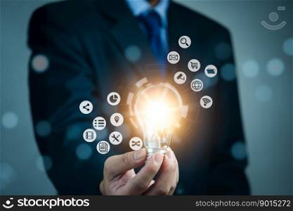 Businessman holding light bulb and new ideas. Creative and inspiration.business with innovative technology network connection. Innovation finance and economic growth concept.