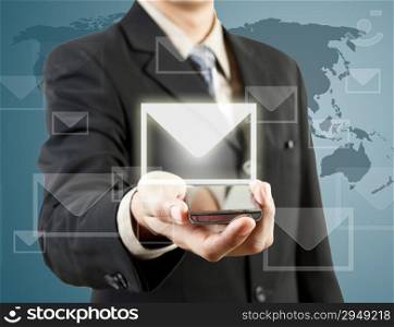 Businessman holding mobile phone and mail