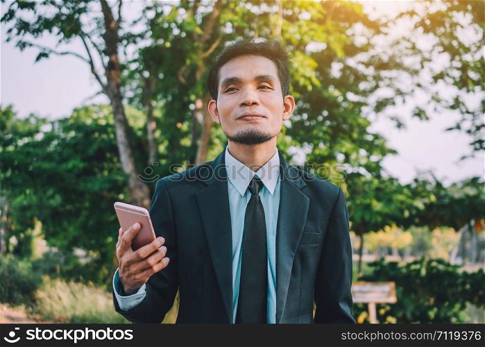 Businessman holding mobile smart phone