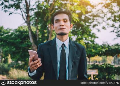 Businessman holding mobile smart phone