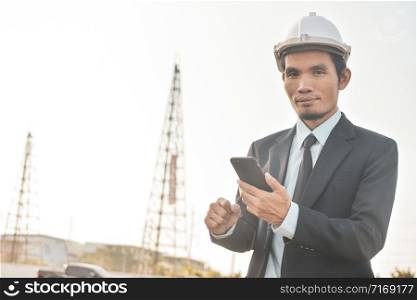 Businessman holding mobile smart phone communication building estate construction background